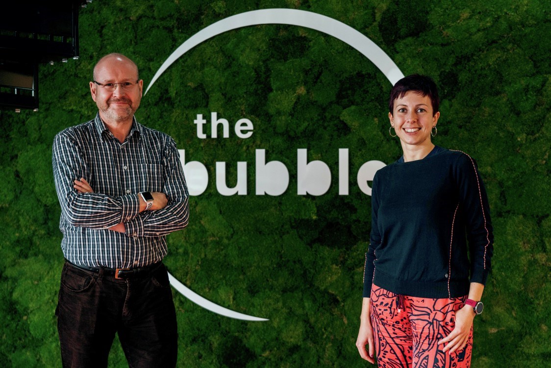 Charles McGurk and Delphine Crappe in front of The Bubble logo wall
