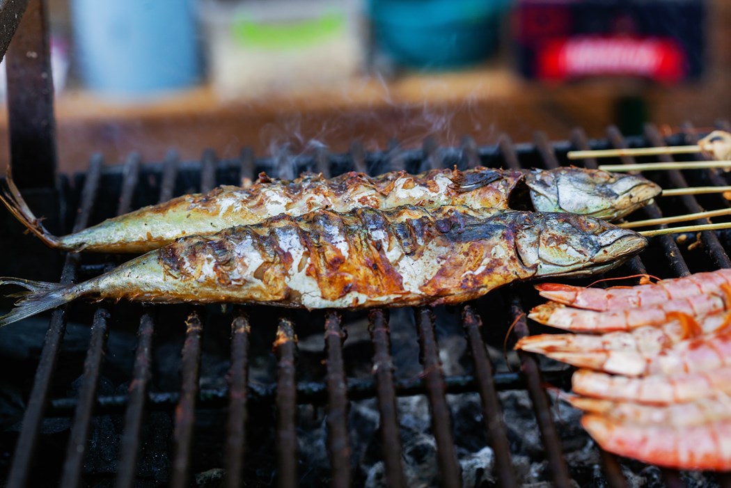 A photo of fish being grilled on a barbecue