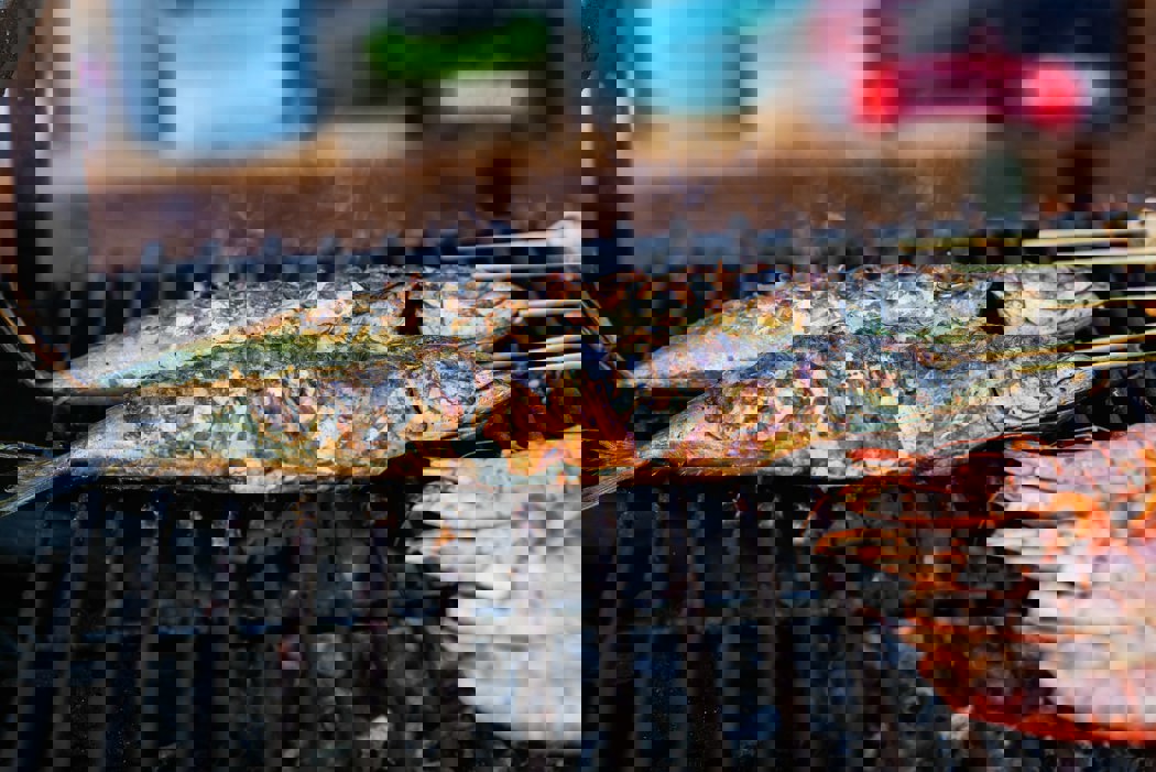 A photo of fish being grilled on a barbecue