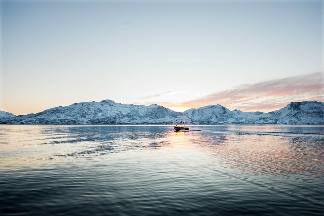 Fjord with boat and snow